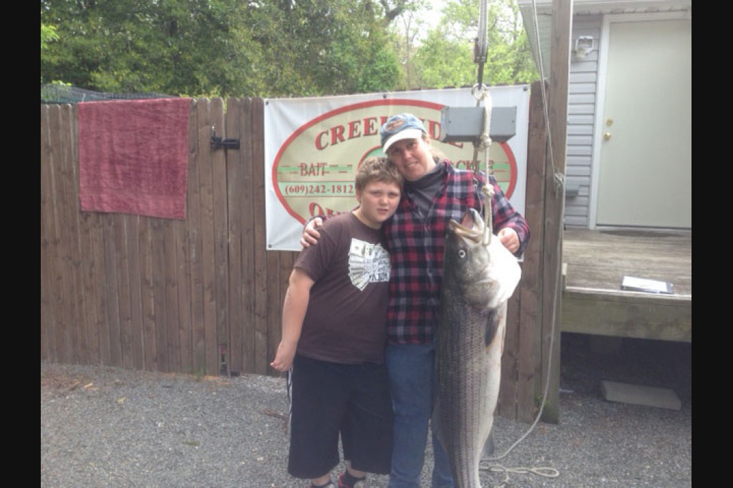 Lisa Dealy and her son caught Striper 34.20 lbs 